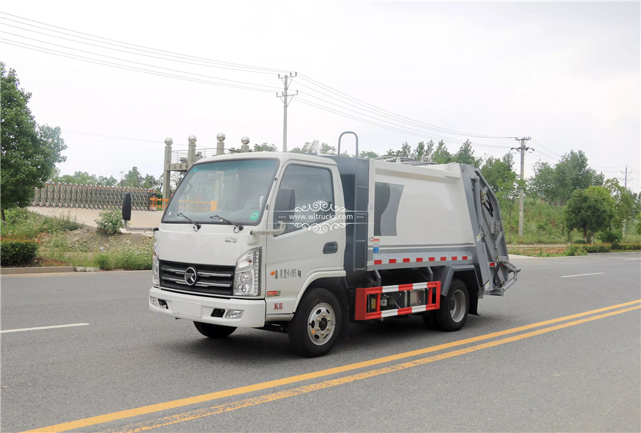 Rear loading garbage compactor truck