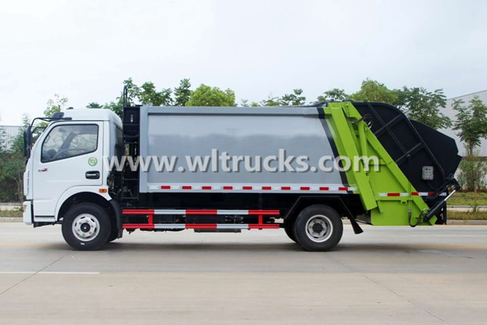 Side view of compactor garbage truck